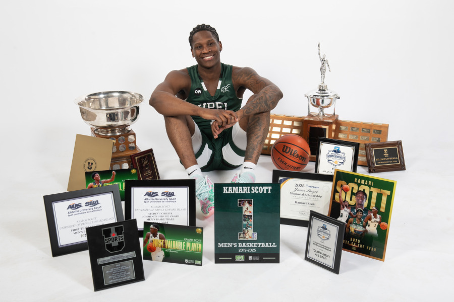 Kamari Scott poses with the awards he has earned throughout his six years at UPEI.