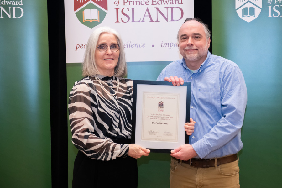 Dr. Wendy Rodgers, UPEI president and vice-chancellor, presents the award to Dr. Paul Bernard